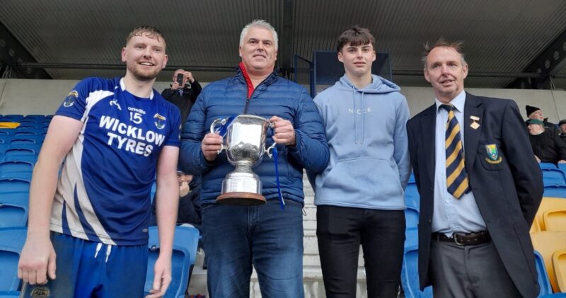Feargal Donoghue pictured presenting the Miley Cup to Tommy Kelly from St Pats alongside his son Conor Donoghue